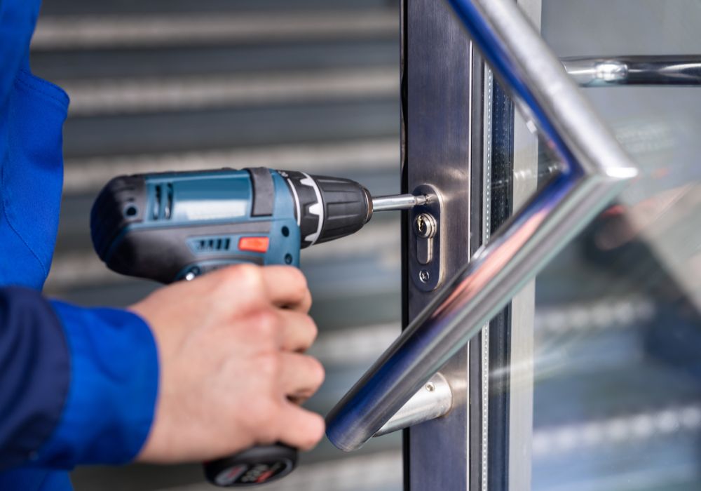 Locksmith drilling to replace a commercial door lock in Amsterdam